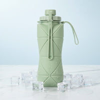 Foldo sage green foldable silicone water bottle showing origami fold body and cap